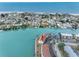 Beautiful waterfront condo complex with canal access and manicured grounds seen from an aerial view at 12360 Capri N Cir # 106, Treasure Island, FL 33706