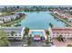 Stunning aerial view of a community pool near a canal surrounded by landscaped grounds at 12360 Capri N Cir # 106, Treasure Island, FL 33706