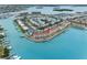 Aerial view of waterfront condo with boat docks and manicured grounds with waterfront views at 12360 Capri N Cir # 106, Treasure Island, FL 33706
