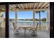 Balcony with seating overlooking beautiful water views perfect for outdoor dining and relaxation at 12360 Capri N Cir # 106, Treasure Island, FL 33706