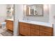 Bathroom boasting double vanity with stone countertop, wood cabinetry, and modern fixtures at 12360 Capri N Cir # 106, Treasure Island, FL 33706