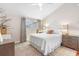 Bright bedroom featuring a ceiling fan, neutral walls, and light wood furniture at 12360 Capri N Cir # 106, Treasure Island, FL 33706