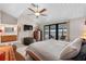 Bedroom featuring a private balcony, en suite bathroom, and a ceiling fan providing comfort and convenience at 12360 Capri N Cir # 106, Treasure Island, FL 33706