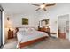 Comfortable bedroom with neutral colors, ceiling fan, and hardwood floors creating a relaxing retreat at 12360 Capri N Cir # 106, Treasure Island, FL 33706