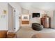 Bright bedroom with an en suite bathroom, TV and hardwood floors creating a comfortable and functional space at 12360 Capri N Cir # 106, Treasure Island, FL 33706