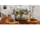 Bright dining room featuring hardwood floors, glass table, and modern decor at 12360 Capri N Cir # 106, Treasure Island, FL 33706
