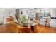 Bright dining room featuring hardwood floors, glass table, and modern decor at 12360 Capri N Cir # 106, Treasure Island, FL 33706