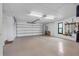 Spacious garage with a painted floor, tools hung on the wall, and a window at 12360 Capri N Cir # 106, Treasure Island, FL 33706
