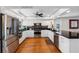 Modern kitchen with stainless steel appliances, white cabinets, and hardwood floors at 12360 Capri N Cir # 106, Treasure Island, FL 33706