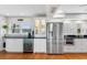 Modern kitchen with stainless steel appliances and white cabinets at 12360 Capri N Cir # 106, Treasure Island, FL 33706