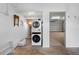 Laundry room area leading to a garage with painted floors and a utility sink at 12360 Capri N Cir # 106, Treasure Island, FL 33706