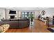 Spacious living room featuring hardwood floors, a fireplace, and sliding glass doors to the balcony at 12360 Capri N Cir # 106, Treasure Island, FL 33706