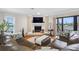 Cozy living room featuring a fireplace, comfortable seating, and a sliding glass door to the balcony at 12360 Capri N Cir # 106, Treasure Island, FL 33706