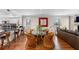 Open-concept living area with hardwood floors, a waterfront view, and bar stool kitchen seating at 12360 Capri N Cir # 106, Treasure Island, FL 33706