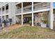 Rear view of patio with multiple columns and a green lawn at 12360 Capri N Cir # 106, Treasure Island, FL 33706