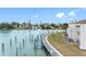Scenic waterfront view featuring a private dock, a waterside pathway, and serene community ambiance at 12360 Capri N Cir # 106, Treasure Island, FL 33706