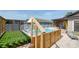 Backyard with a hot tub, wooden enclosure, a small deck, and a lounge chair on stone pavers at 12595 95Th N St, Largo, FL 33773