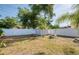 Spacious backyard featuring mature trees, a shed, and a white fence, creating a private outdoor oasis at 12595 95Th N St, Largo, FL 33773