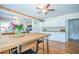 Kitchen featuring hardwood floors, white cabinets, stylish fixtures, and an adjacent dining area at 12595 95Th N St, Largo, FL 33773