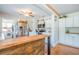 Charming kitchen featuring light cabinets, stainless steel appliances, and an adjacent laundry area at 12595 95Th N St, Largo, FL 33773