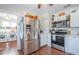 Bright kitchen features stainless steel appliances and updated cabinetry with an adjacent laundry room at 12595 95Th N St, Largo, FL 33773