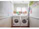 Laundry room features side-by-side washer and dryer set and shelving near a window at 12595 95Th N St, Largo, FL 33773