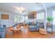 Cozy living room with hardwood floors, a whitewashed brick fireplace, and comfortable gray furnishings at 12595 95Th N St, Largo, FL 33773