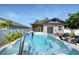 Backyard with an endless pool, lounge chairs, and barbecue, creating an inviting outdoor space at 12595 95Th N St, Largo, FL 33773