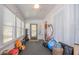 Bright and airy sunroom with white walls and ceiling, featuring lots of natural light and a ceiling fan at 12595 95Th N St, Largo, FL 33773