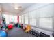 Bright sunroom with ample windows, neutral walls, and a ceiling fan, set up as an exercise area at 12595 95Th N St, Largo, FL 33773