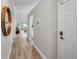 Bright hallway featuring wood floors and view into the living room and dining area at 1288 Powderpuff Dr # 1202, Dunedin, FL 34698