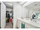 Bathroom with double sinks and a walk-in closet at 13003 Titleist Dr, Hudson, FL 34669