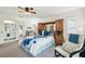 Bright bedroom with a queen bed, desk, and ensuite bath at 13003 Titleist Dr, Hudson, FL 34669