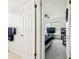 Bedroom with a view showing an open door, leading to a bedroom with a ceiling fan and window at 13003 Titleist Dr, Hudson, FL 34669