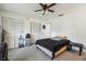 Bedroom featuring ceiling fan, carpet, ample closet space, and neutral decor at 13003 Titleist Dr, Hudson, FL 34669