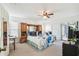 Spacious bedroom with a queen bed and access to the back patio at 13003 Titleist Dr, Hudson, FL 34669