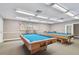 Billiard room featuring two pool tables, overhead lighting, and a neutral color palette at 13003 Titleist Dr, Hudson, FL 34669