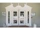 Clubhouse entrance with double doors featuring decorative glass and posted hours at 13003 Titleist Dr, Hudson, FL 34669