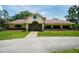 Exterior shot of community clubhouse featuring lush landscaping and welcoming entrance at 13003 Titleist Dr, Hudson, FL 34669