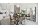 Bright dining area with views to the living room and sliding glass doors to the patio at 13003 Titleist Dr, Hudson, FL 34669