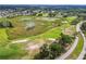 Scenic aerial of a golf course with sand traps, trees, and wetlands, set in a residential community at 13003 Titleist Dr, Hudson, FL 34669