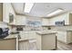 Bright kitchen with island, white cabinets, granite countertops, and stainless steel appliances at 13003 Titleist Dr, Hudson, FL 34669