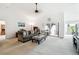 Cozy living room with a vaulted ceiling and sliding glass doors to the patio at 13003 Titleist Dr, Hudson, FL 34669