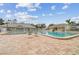 Community pool area featuring a large pool, brick pavers, and lounge chairs at 13003 Titleist Dr, Hudson, FL 34669