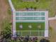 Aerial view of community shuffleboard courts featuring covered seating, with pristine playing conditions at 13003 Titleist Dr, Hudson, FL 34669