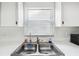 Bright kitchen sink with double basin and window at 13003 Titleist Dr, Hudson, FL 34669