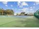 A well-maintained community tennis court with net, benches and blue hardtop, perfect for an active lifestyle at 13003 Titleist Dr, Hudson, FL 34669