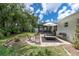 Beautiful backyard featuring patio seating area, lush landscaping, and white exterior at 1313 Markley Dr, Largo, FL 33770
