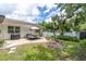 Spacious backyard with patio seating, barbecue, white exterior and lush landscaping at 1313 Markley Dr, Largo, FL 33770
