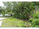 Spacious backyard featuring shed, lush landscaping with palms and green lawn at 1313 Markley Dr, Largo, FL 33770
